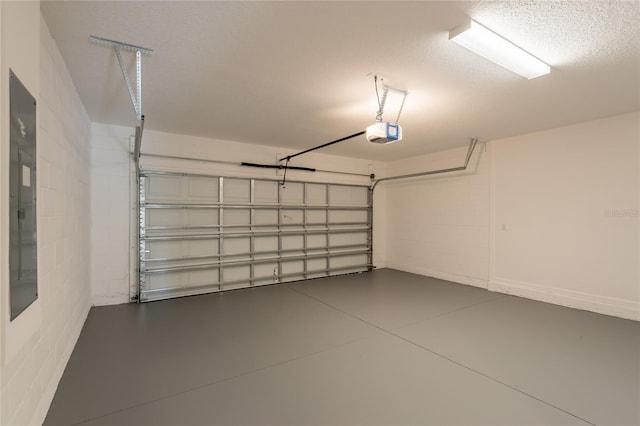 3840 Fescue St, Clermont, FL 34714 - garage featuring a garage door opener and concrete block wall