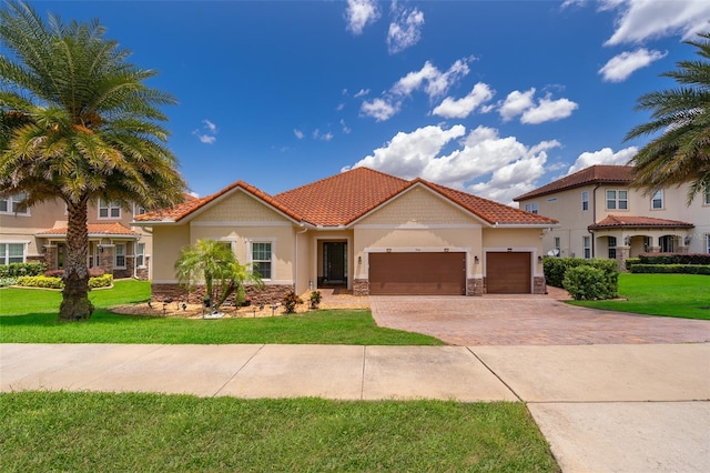 3546 Mediterra Dr, Clermont, FL 34711 - view of front of house with stone siding, an attached garage, driveway, and stucco siding
