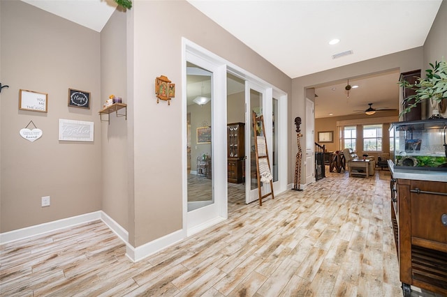 3546 Mediterra Dr, Clermont, FL 34711 - hallway featuring light wood-style floors, french doors, and recessed lighting