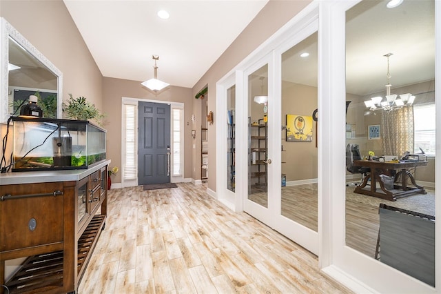 3546 Mediterra Dr, Clermont, FL 34711 - foyer entrance with light wood-style floors, french doors, a chandelier, recessed lighting, and vaulted ceiling