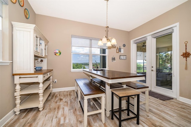 3546 Mediterra Dr, Clermont, FL 34711 - dining room with light wood finished floors, a chandelier, and plenty of natural light