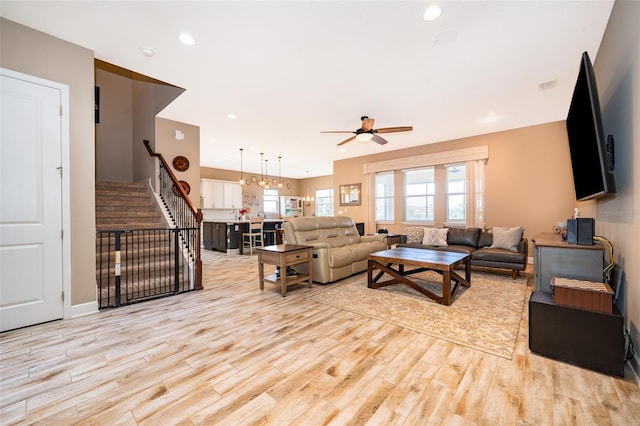3546 Mediterra Dr, Clermont, FL 34711 - living area featuring stairs, ceiling fan, wood finished floors, and recessed lighting