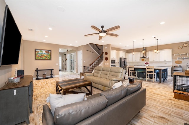 3546 Mediterra Dr, Clermont, FL 34711 - living room featuring light wood-style flooring, stairway, a ceiling fan, and recessed lighting