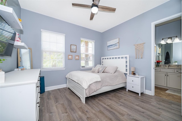 3546 Mediterra Dr, Clermont, FL 34711 - bedroom featuring wood finished floors, ensuite bath, and ceiling fan
