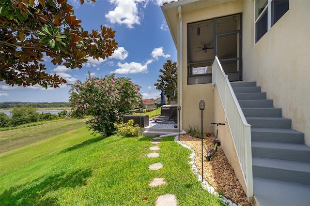 3546 Mediterra Dr, Clermont, FL 34711 - view of green lawn with a water view and stairway