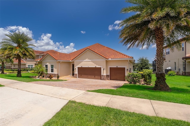 3546 Mediterra Dr, Clermont, FL 34711 - mediterranean / spanish house with driveway, a front yard, a garage, and a tile roof
