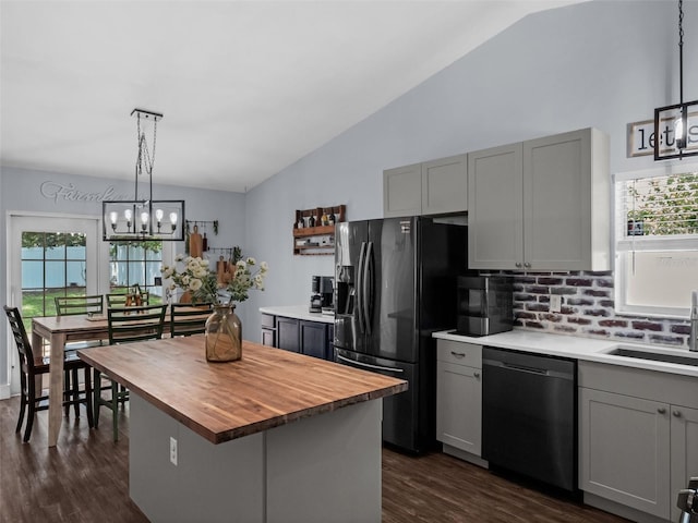 15718 Carriage Hill Ct, Clermont, FL 34711 - kitchen featuring stainless steel dishwasher, wood counters, gray cabinetry, lofted ceiling, and plenty of natural light