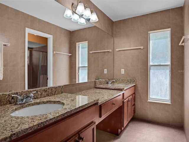 15718 Carriage Hill Ct, Clermont, FL 34711 - bathroom featuring tile walls, double vanity, tile patterned flooring, and plenty of natural light