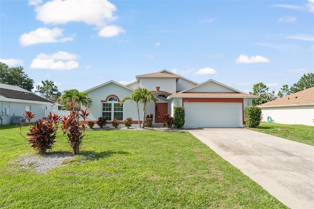 11341 Autumn Wind Loop, Clermont, FL 34711 - view of front of home with an attached garage, driveway, a front yard, and stucco siding