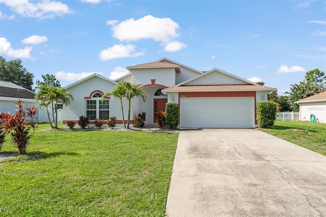 11341 Autumn Wind Loop, Clermont, FL 34711 - view of front of home featuring an attached garage, concrete driveway, and stucco siding
