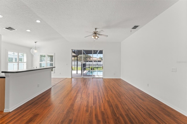 11341 Autumn Wind Loop, Clermont, FL 34711 - unfurnished living room featuring a textured ceiling, wood finished floors, a chandelier, recessed lighting, and ceiling fan