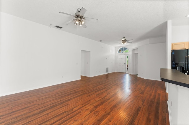 11341 Autumn Wind Loop, Clermont, FL 34711 - unfurnished living room with a ceiling fan, dark wood-type flooring, and a textured ceiling