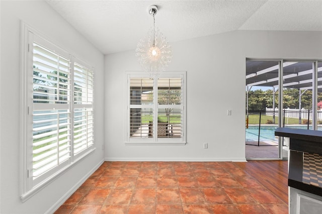 11341 Autumn Wind Loop, Clermont, FL 34711 - unfurnished dining area with a chandelier, vaulted ceiling, and a textured ceiling