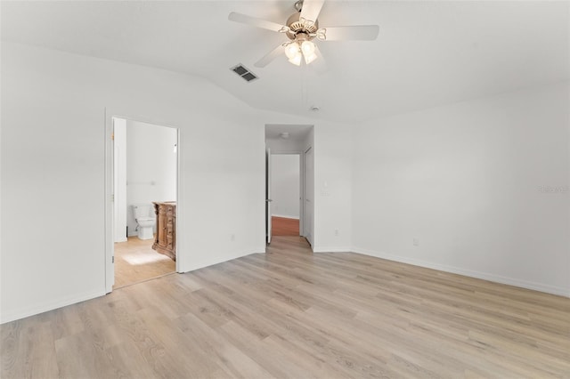 11341 Autumn Wind Loop, Clermont, FL 34711 - unfurnished bedroom featuring light wood-style floors, lofted ceiling, connected bathroom, and ceiling fan