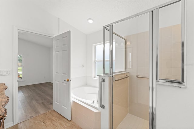 11341 Autumn Wind Loop, Clermont, FL 34711 - full bath with a bath, a stall shower, lofted ceiling, and wood finished floors