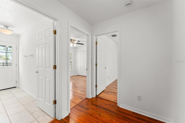 11341 Autumn Wind Loop, Clermont, FL 34711 - hall with light wood-style flooring and baseboards