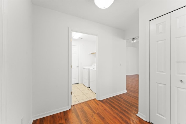 11341 Autumn Wind Loop, Clermont, FL 34711 - hallway with washer and dryer and wood finished floors