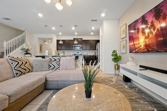 927 Paradise Dr, Davenport, FL 33897 - living room featuring stairs, light marble finish floors, and recessed lighting