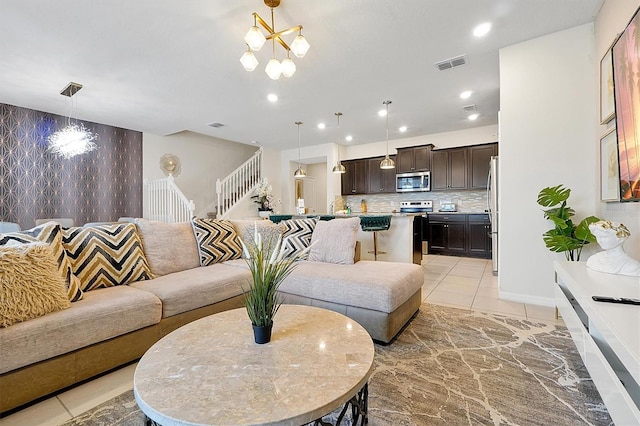 927 Paradise Dr, Davenport, FL 33897 - living room with stairway, an accent wall, recessed lighting, and a chandelier