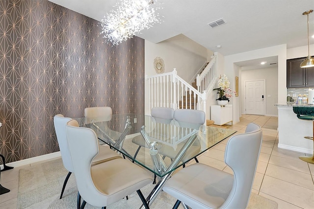 927 Paradise Dr, Davenport, FL 33897 - dining area with stairs, light tile patterned floors, an accent wall, and recessed lighting