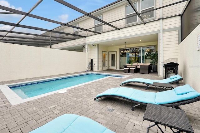 927 Paradise Dr, Davenport, FL 33897 - outdoor pool with a patio area, an outdoor living space, and glass enclosure