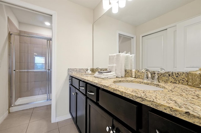 927 Paradise Dr, Davenport, FL 33897 - bathroom featuring tile patterned floors, double vanity, a shower stall, and recessed lighting