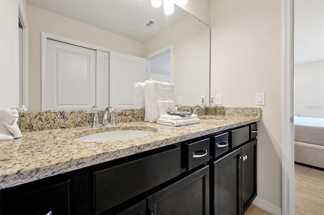 927 Paradise Dr, Davenport, FL 33897 - ensuite bathroom with double vanity and baseboards