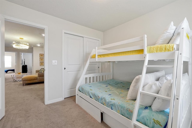 927 Paradise Dr, Davenport, FL 33897 - bedroom featuring carpet, a closet, and a chandelier