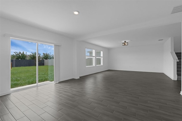 617 Hitch Loop, Saint Cloud, FL 34772 - unfurnished living room featuring dark wood-type flooring and recessed lighting