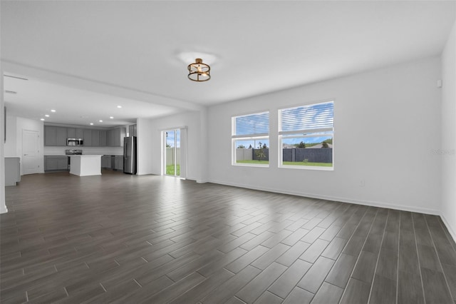 617 Hitch Loop, Saint Cloud, FL 34772 - unfurnished living room featuring dark wood finished floors and recessed lighting