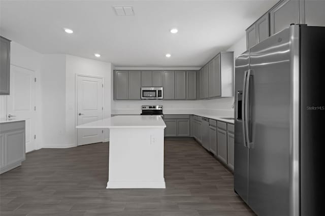 617 Hitch Loop, Saint Cloud, FL 34772 - kitchen with appliances with stainless steel finishes, gray cabinetry, recessed lighting, a kitchen island, and light countertops