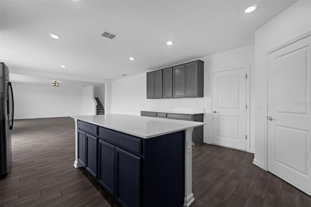 617 Hitch Loop, Saint Cloud, FL 34772 - kitchen with dark wood-style flooring, light countertops, recessed lighting, a center island, and refrigerator
