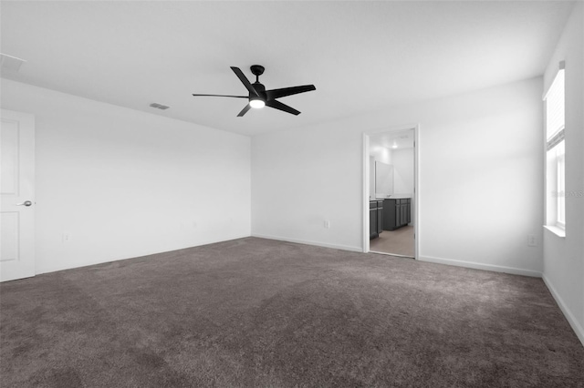 617 Hitch Loop, Saint Cloud, FL 34772 - unfurnished bedroom with multiple windows, carpet flooring, a ceiling fan, and ensuite bathroom