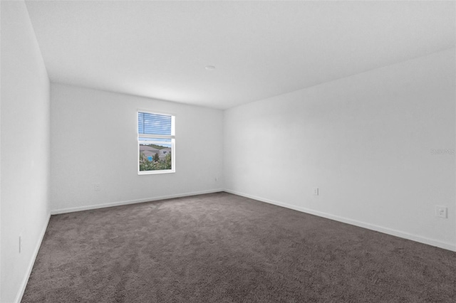 617 Hitch Loop, Saint Cloud, FL 34772 - spare room featuring dark carpet and baseboards