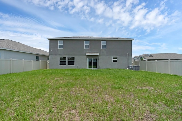 617 Hitch Loop, Saint Cloud, FL 34772 - rear view of house with stucco siding and solar panels