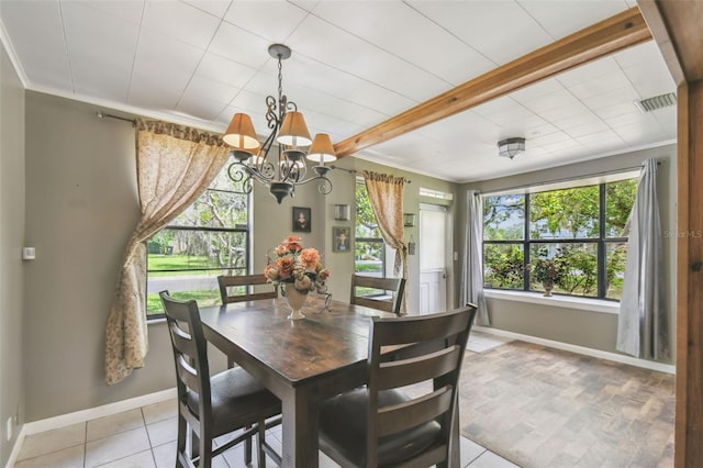 1108 W Minnehaha Ave, Clermont, FL 34711 - dining space featuring a chandelier, crown molding, and light tile patterned floors