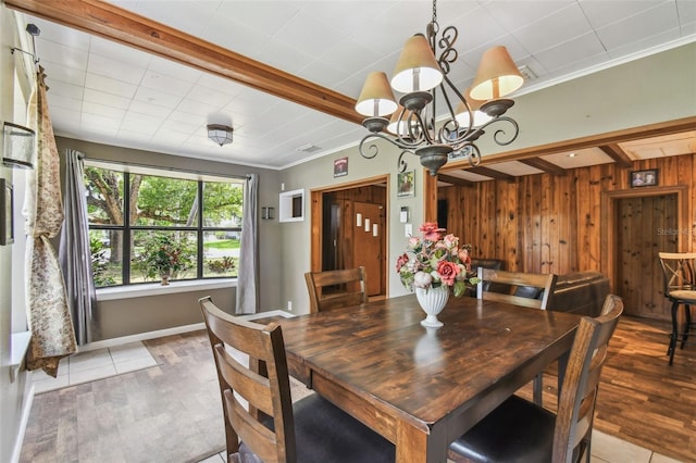 1108 W Minnehaha Ave, Clermont, FL 34711 - dining space featuring wood finished floors, wood walls, a chandelier, crown molding, and beamed ceiling