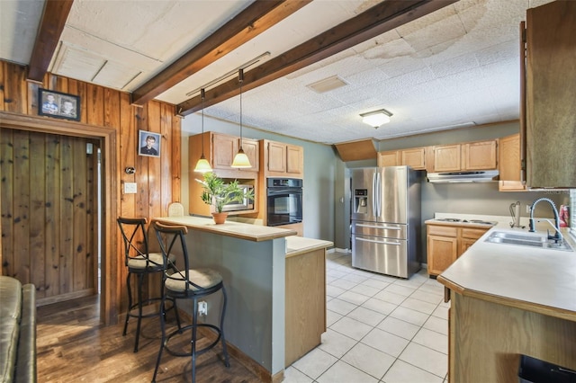 1108 W Minnehaha Ave, Clermont, FL 34711 - kitchen with stainless steel fridge with ice dispenser, under cabinet range hood, oven, a peninsula, and beamed ceiling