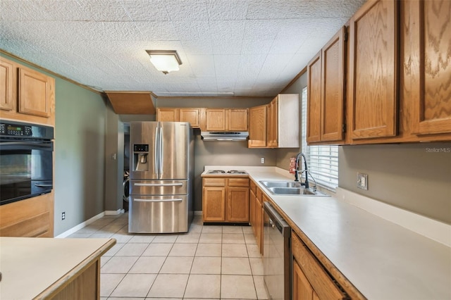1108 W Minnehaha Ave, Clermont, FL 34711 - kitchen featuring appliances with stainless steel finishes, light tile patterned floors, light countertops, under cabinet range hood, and brown cabinets