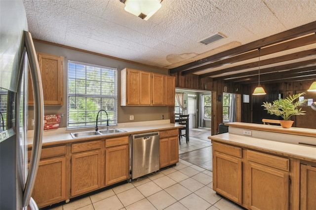 1108 W Minnehaha Ave, Clermont, FL 34711 - kitchen with stainless steel appliances, light countertops, light tile patterned flooring, healthy amount of natural light, and wooden walls