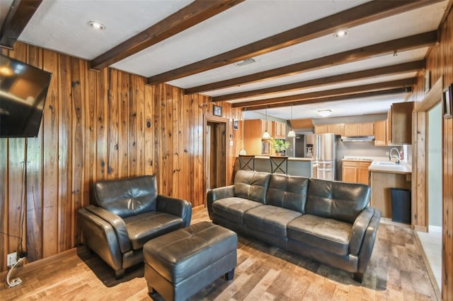 1108 W Minnehaha Ave, Clermont, FL 34711 - living room featuring beamed ceiling, light wood-type flooring, and wooden walls