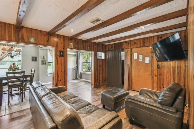 1108 W Minnehaha Ave, Clermont, FL 34711 - living area with beamed ceiling, wood walls, and wood finished floors