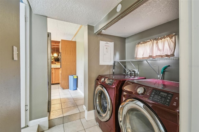 1108 W Minnehaha Ave, Clermont, FL 34711 - laundry room featuring washing machine and clothes dryer, tile patterned flooring, a textured ceiling, and electric panel