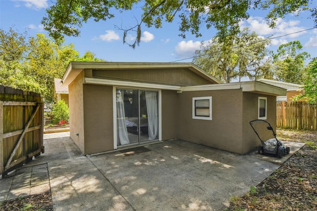 1108 W Minnehaha Ave, Clermont, FL 34711 - rear view of property with stucco siding and a patio