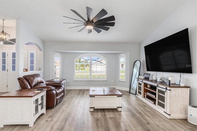 198 Porto Velho St, Punta Gorda, FL 33983 - living room with vaulted ceiling, light wood-style floors, a ceiling fan, arched walkways, and a chandelier