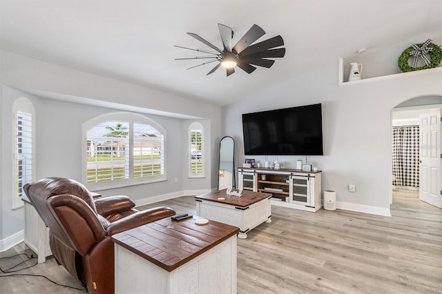 198 Porto Velho St, Punta Gorda, FL 33983 - living room featuring ceiling fan, light wood-style flooring, vaulted ceiling, and arched walkways