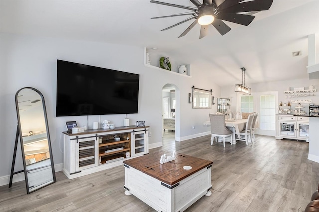 198 Porto Velho St, Punta Gorda, FL 33983 - living area with arched walkways, ceiling fan, light wood-style floors, and vaulted ceiling