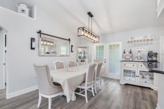 198 Porto Velho St, Punta Gorda, FL 33983 - dining room featuring french doors, wood finished floors, arched walkways, lofted ceiling, and a chandelier