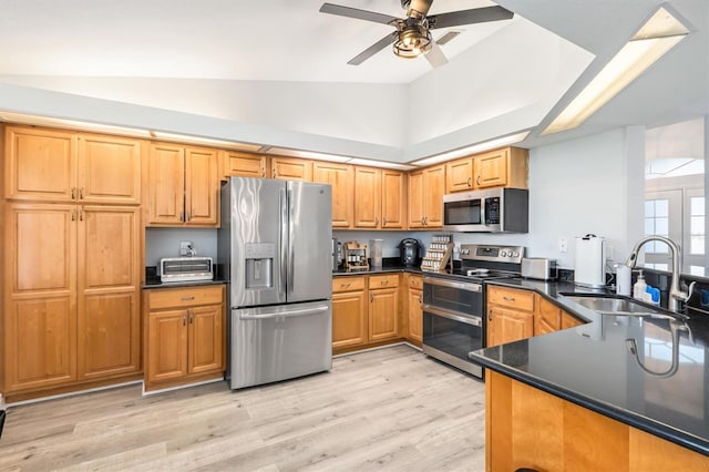 198 Porto Velho St, Punta Gorda, FL 33983 - kitchen with appliances with stainless steel finishes, vaulted ceiling, a ceiling fan, dark countertops, and a peninsula