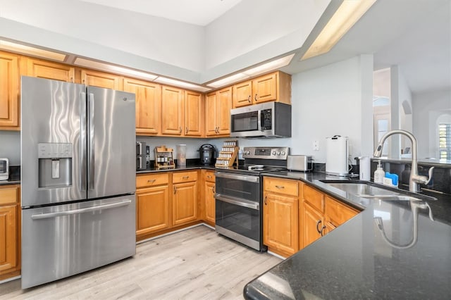 198 Porto Velho St, Punta Gorda, FL 33983 - kitchen with stainless steel appliances, light wood-style floors, arched walkways, and dark stone countertops